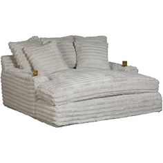 a large white chair with two pillows on it