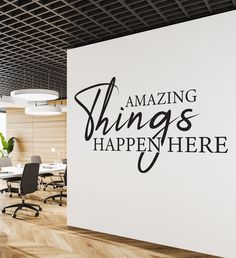 an office wall with the words amazing things happen here on it in black and white