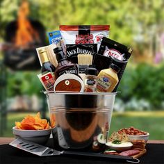 a large metal bucket filled with food and condiments on top of a table