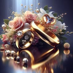 two gold wedding rings surrounded by flowers and pearls on a reflective surface with sunlight streaming through the background