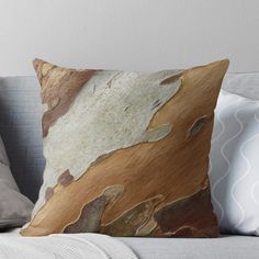 a close up view of a tree trunk with brown and white paint on it throw pillow