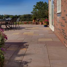 an outdoor patio area with tables and chairs