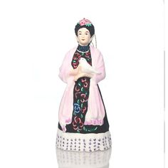 a figurine is shown in front of a white background with the image of a woman