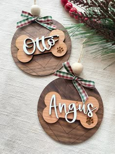 two wooden ornaments with the words august and an ornament hanging from each one