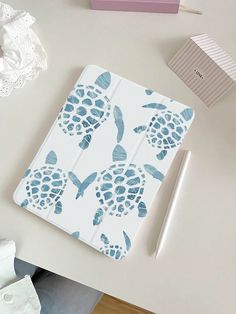 an open notebook with blue sea turtles on it