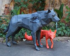 a sculpture of a dog and a cat made out of paper