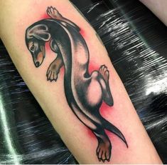 an animal tattoo on the leg of a person's arm, showing it's tail