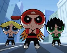 the powerpuff girls are standing in front of each other on a city street