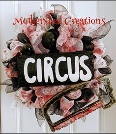 a close up of a wreath on a door with the words circus written on it