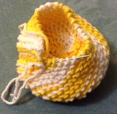 a yellow and white crochet bag with a pair of scissors