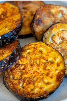 grilled eggplant slices on a plate ready to be eaten