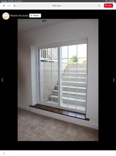 an empty room with a window and some blinds on the windowsill in front of it