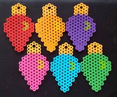 six perfored pieces of different colors on a black surface