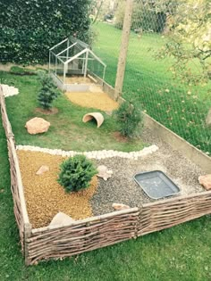 a dog house in the middle of a yard with rocks and gravel on the ground