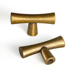 two brass knobs on a white background