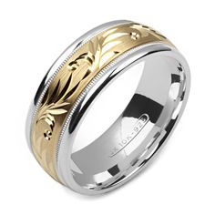 two tone gold and silver wedding ring with floral design on the center, inlayed to an engraving pattern