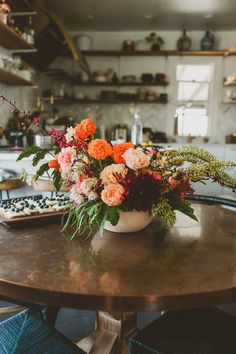 an image of flowers in a vase on top of a table with twitter posts about it