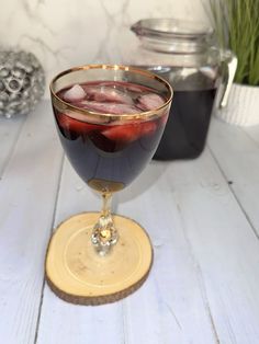 a glass filled with liquid sitting on top of a table