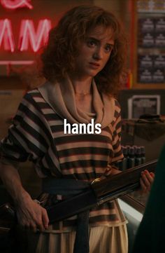 a woman standing in front of a counter holding a knife