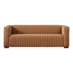 a brown couch sitting on top of a white floor