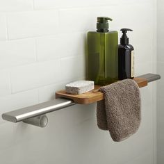 a bathroom shelf with soap and lotion on it