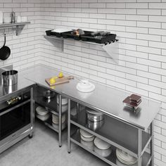 an industrial style kitchen with stainless steel appliances and white brick wall behind the stovetop