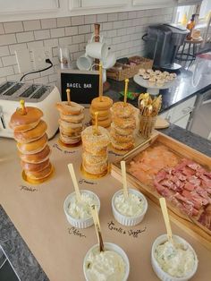 an assortment of pastries and bagels on a counter