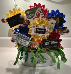 a white bucket filled with lots of different types of candies and candy wrappers