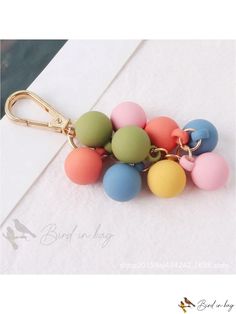 a bunch of small plastic balls on a keychain