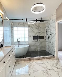 a large bathroom with marble floors and white walls, along with a walk in shower