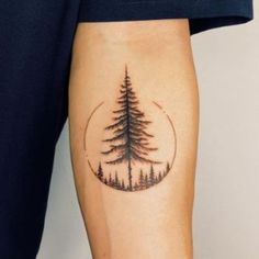 a person with a tree tattoo on their leg and the bottom half of his arm