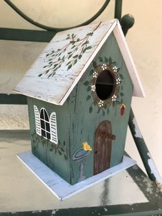 a green birdhouse sitting on top of a table