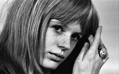 black and white photograph of a woman with long hair holding her hand up to her face