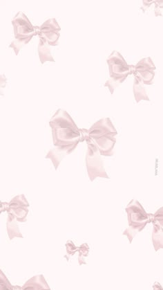 a pink wallpaper with large bows on it