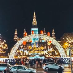 cars are parked in front of a lighted archway