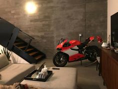 a red motorcycle is parked in the living room