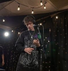 two young men standing next to each other in front of microphones