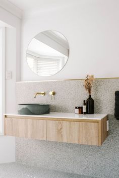 there is a sink and mirror in the bathroom with marble counter tops on both sides