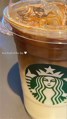 there is a cup of coffee with ice in it and the lid has a starbucks logo on it