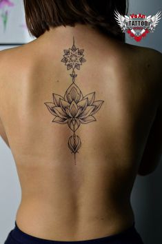 a woman with a lotus tattoo on her back