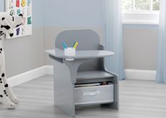 a child's desk with a dalmatian dog statue next to it in the corner