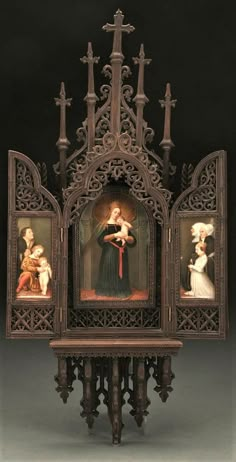 an ornate wooden shrine with paintings on the front and back sides, including a woman holding a child