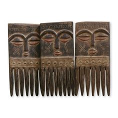 three wooden combs with designs on them, one has eyes and the other has teeth