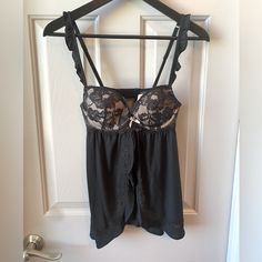 - New With Tags - Black Open Front Babydoll Nightie Top - Built In Lace Underwire Bra With Light Pink Lining - Size 34b - Adjustable Staps - Underwire Bra - 90% Modal / 10% Elastane - Does Not Come With The Matching Panties Coquette Chemise With Built-in Bra For Night, Black Lace Camisole In Flirty Style, Black Lace Camisole In Feminine Style, Black Lace Coquette Camisole, Victoria's Secret Lace Sleepwear With Built-in Bra, Lace Sleepwear With Built-in Underwire Bra, Black Lace Sleepwear For Loungewear, Underwire Sleepwear With Built-in Bra For Bedtime, Victoria's Secret Coquette Lace Sleepwear