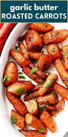 garlic butter roasted carrots in a white bowl with parsley on top and text overlay that reads garlic butter roasted carrots