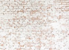 an old brick wall with white paint