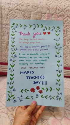 a hand holding up a thank card with flowers on it