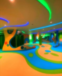 an indoor play area with colorful paint on the floor