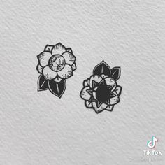 two black and white flowers on a white background