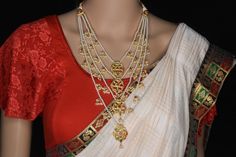 About the Jewellery  From fashion to jewelry, a resurgence of heritage styles is ruling bridal fashion right now, and nothing spells a royal bride more than these ornate layered necklaces. A symbol of nobility in the Deccan in ancient times, Panchladas (5-strand) and Satladas (7-strand) are regal necklaces crafted from pearls,  and other gemstones. This vintage style rani-haar's return to popularity can be credited to designer Sabyasachi Mukherjee. Today, these bold, yet classy necklaces can mak Elegant Temple Necklace For Diwali Marriage, Elegant Temple Necklace For Marriage And Diwali, Elegant Temple Necklace For Marriage During Diwali, Elegant Ceremonial Necklaces With Motifs, Traditional Gold Pearl Necklace For Marriage, Wedding Chandbali Kundan Necklace With Motifs, Wedding Kundan Chandbali Necklace With Motifs, Elegant Kundan Chandbali Necklace With Motifs, Elegant Heavy Temple Necklace For Marriage